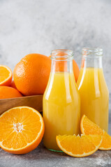 A wooden old box full of juicy orange fruit on stone background