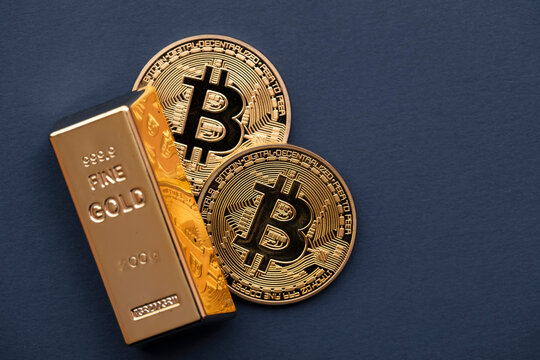Bitcoin cryptocurrency coin with a gold bullion bar. Investment concept