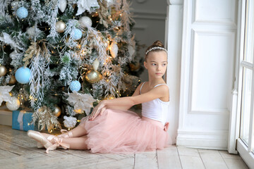 A small ballerina near the Christmas tree. The Nutcracker . New Year's gifts