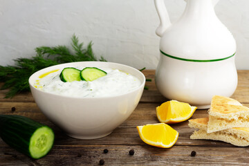Traditional greek sauce tzatziki in a white bowl