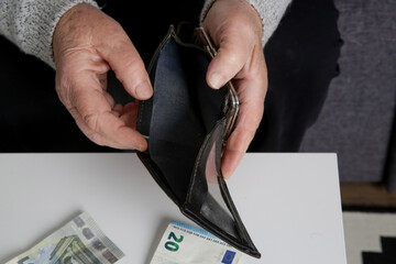 Senior woman looking at empty wallet