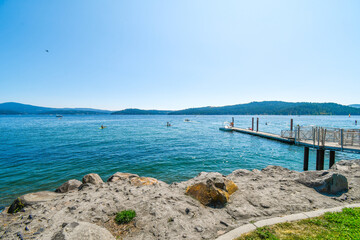 Fototapeta premium A small boat launch and dock near City Park and Beach at the lake in Coeur d'Alene, Idaho, USA.