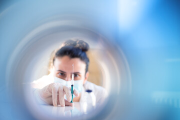 Nurse or female doctor prepairs anti COVID-19 vaccine dose for a patient