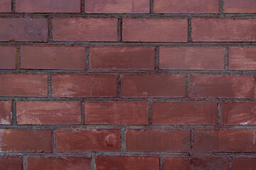 Red brick wall with dim light for background.