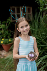Little girl holding a nest with eggs
