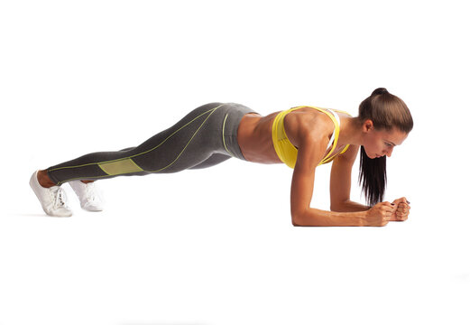 photo of sporty woman doing exercise elbow planking isolated on white background