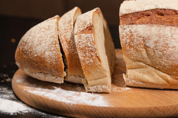 Bread and flour on a wooden board. Homemade baking.