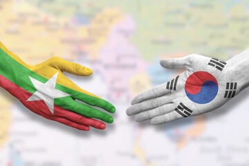 Myanmar and South Korea - Flag handshake symbolizing help, assistance and cooperation with Burma