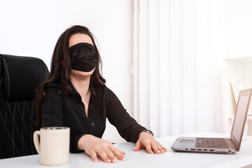 Funny concept of a girl taking a break at the office with a mask over her eyes.