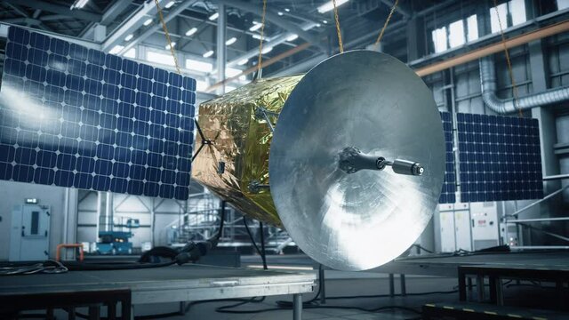 Satellite Under Construction in Aerospace Technology Manufacturing Facility. Development of Spacecraft for Space Exploration, Navigation, Communications, Internet Telecommunication, Observation 