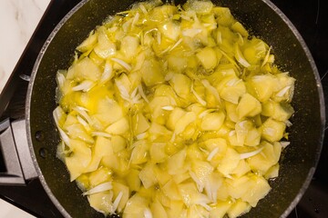 Potatoes with onions frying in a pan