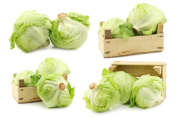 fresh iceberg lettuce in a wooden crate on a white background