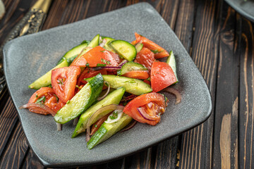 salad with cucumbers, tomatoes, red cabbage and arugula