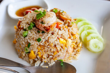 Shrimp fried rice in a white plate on the table