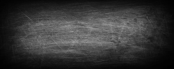 Dark, grunge and scratched chalkboard texture with empty space for text