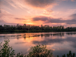 Obraz na płótnie Canvas Riverside Sunrise with Cloud Reflections