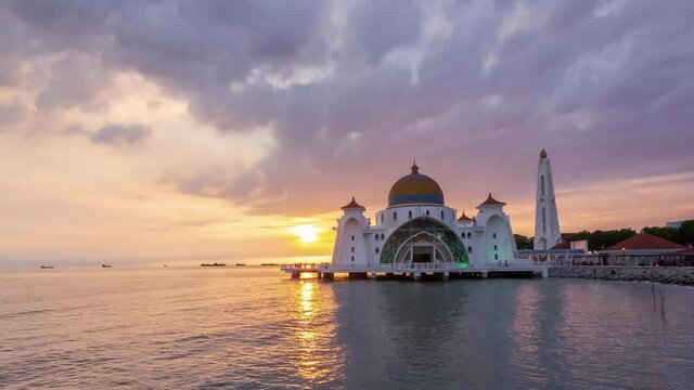 Dramatic sunset view at Majestic Glowing Strait Mosque of Malacca, Malaysia. The mosque is known as Masjid Selat among local folk
