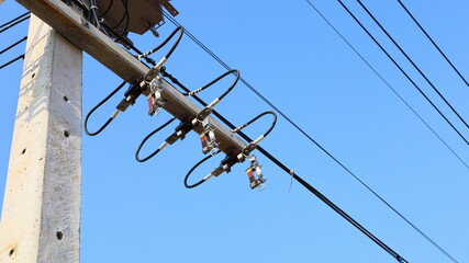 Obraz premium Disconnect the fuse. Short circuit protection device on high voltage pole is not connected in bottom view on clear blue background. Selective focus