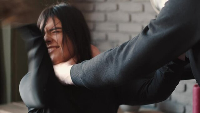 Angry husband beating and choking scared wife at home