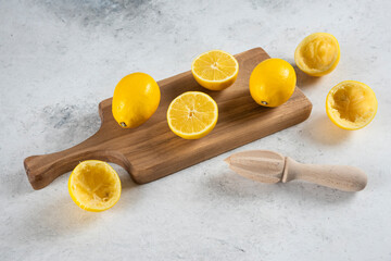 Sliced and whole lemons with wooden reamer