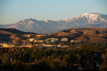 Snow capped mountain sunset view of the downtown area of Brea, California, USA. 