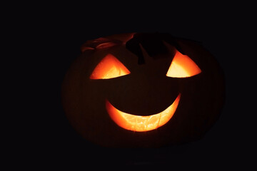 homemade carved glowing pumpkin in the dark