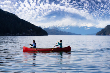 Couple friends canoeing on a wooden canoe