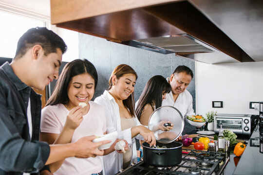 hispanic family in the kitchen cooking together. Healthy food at home in Latin America