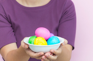 Fototapeta na wymiar Hands holding colorful Easter eggs.