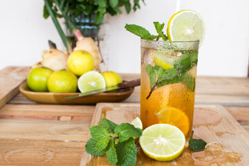 herbal healthy drinks cold honey lemon tea for health care with peppermint leaf and lemon slice arrangement flat lay style on background wooden