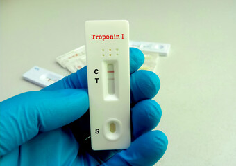 Scientist hold a test device or cassette for Troponin I test. Rapid screening test, myocardial infraction