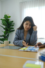 Portrait of businesswoman sitting with her colleague and working together on new project at modern office.