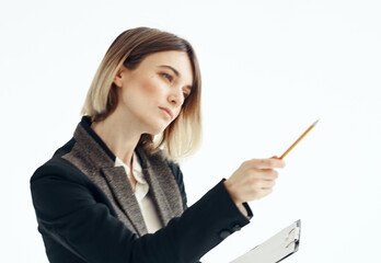 women with a pencil in their hands writes information on a light background work mode