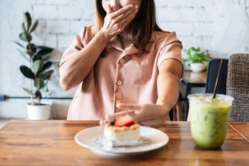 Asian woman hand push out unhealthy food. refused, say no to junk food, healthy eating and diet...