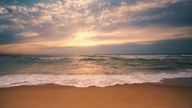 Beach on tropical island and colorful sunrise with dramatic clouds, 4k video