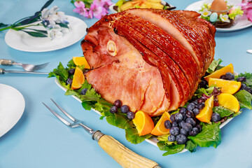 Easter spiral glazed ham on festive table.