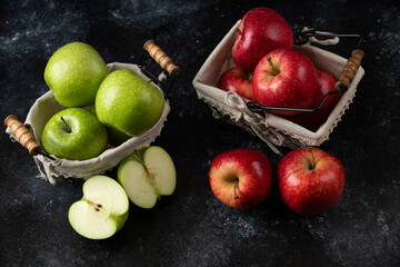 Ripe organic red and green apples in metal baskets