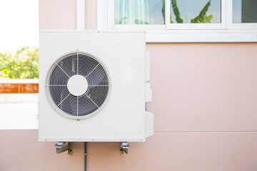 External split wall type of house air conditioner compressor unit installed on the outside of the...