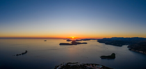 Fototapeta na wymiar Aerial panorama drone shot of sunset horizon in Adriatic islands in Dubrovnik in Croatia summer