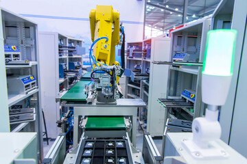 robotic arm catch for electronic assembly line. The robot for smart technology manufacturing process.