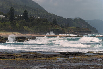 waves crash into the coastline along Wollongong
