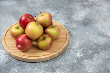 Naklejka na ściany i meble Bunch of fresh ripe apples placed on wooden board