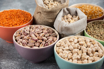 Different type of raw dry legumes composition on marble surface