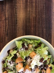 closeup of half salad with empty wood table blank background
