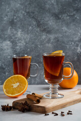 Two glass cups with hot tea and cinnamon sticks