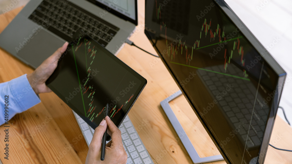 Poster stock exchange trader working with graphs,diagrams on monitor in modern trading office
