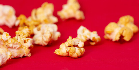 Close-up of popcorn on a red background.