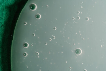 A drop of shampoo on a green background