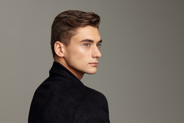 Handsome young guy fashionable hairstyle black jacket attractive look luxury model close-up