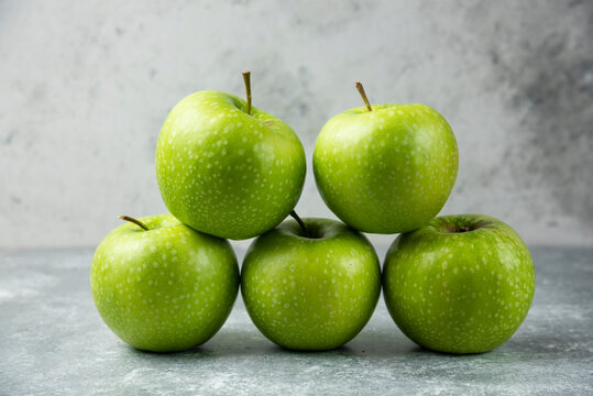Stack of fresh apples on marble background